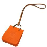 Pre-owned Leather key-holders Hermès Vintage , Orange , Dames