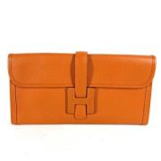 Pre-owned Leather clutches Hermès Vintage , Orange , Dames