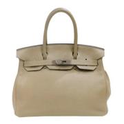 Pre-owned Leather handbags Hermès Vintage , Beige , Dames