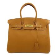 Pre-owned Leather handbags Hermès Vintage , Beige , Dames