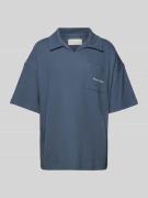 Oversized poloshirt met labelprint