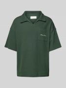 Oversized poloshirt met labelprint
